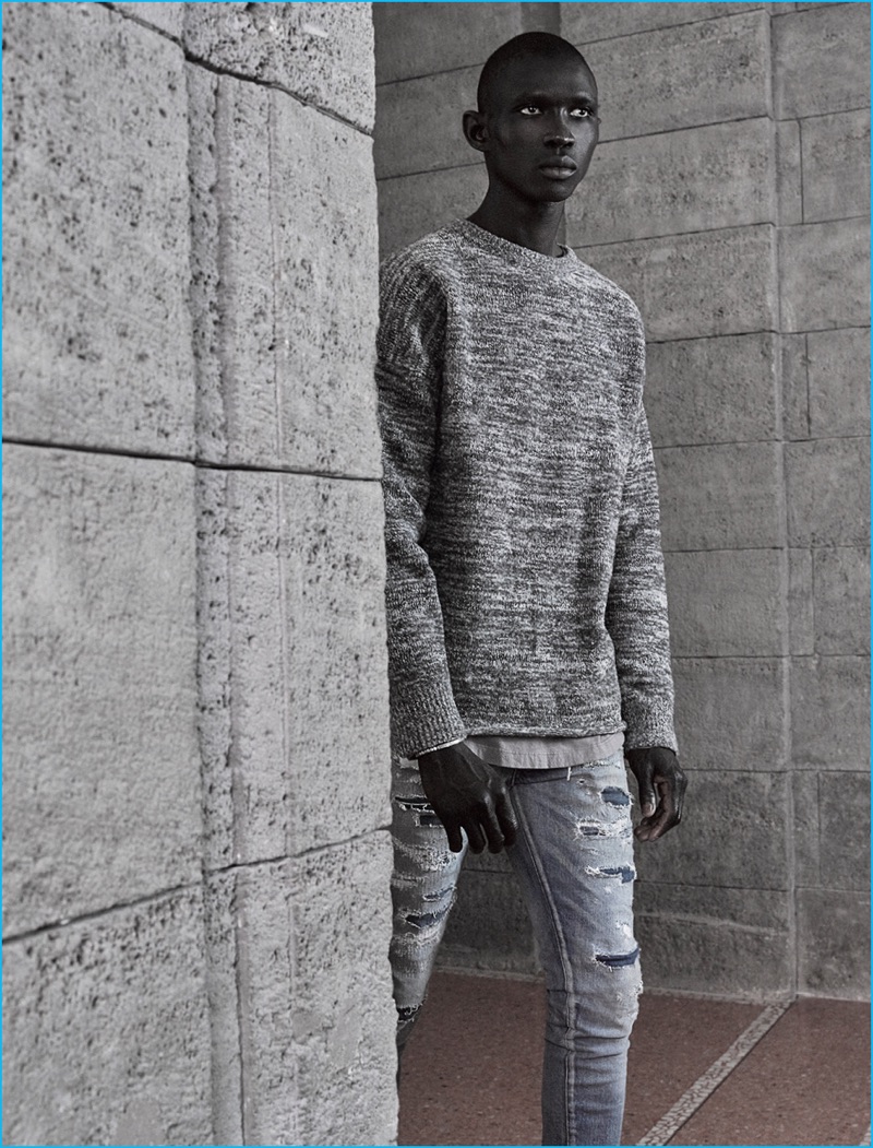 Fernando Cabral pictured in an essential sweater and ripped denim jeans from John Elliott's fall-winter 2016 collection.