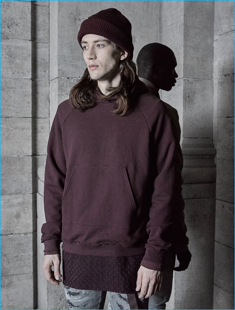 Lucian Clifforth models a burgundy hoodie from John Elliott's fall-winter 2016 collection.