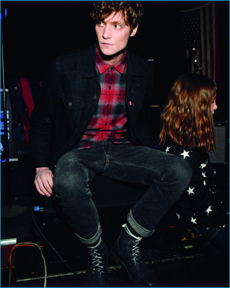 Matthew Hitt models Levi's 505C slim fit denim jeans.