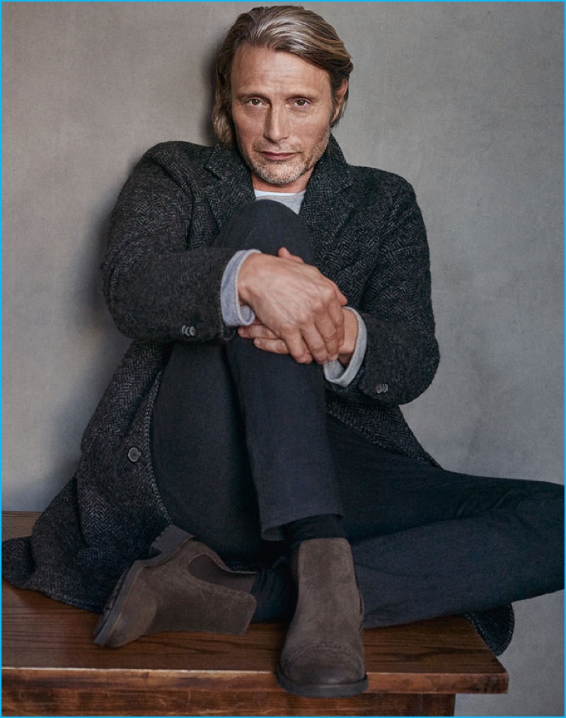 Mads Mikkelsen dons a herringbone coat with slim trousers and suede ankle boots for Marc O'Polo's fall-winter 2016 campaign.