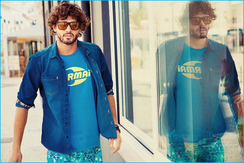 Sporting an open denim shirt and logo tee, Marlon Teixeira channels surfer style for Mormaii's spring-summer 2017 campaign.