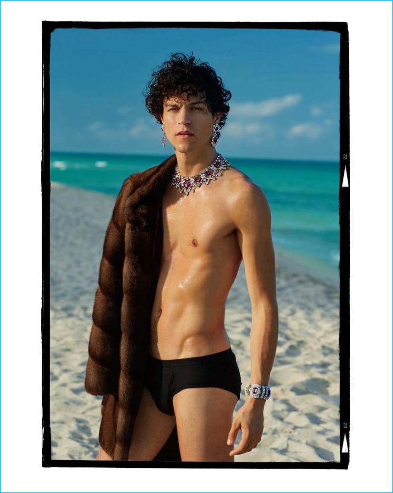 Miles McMillan takes to the beach in a swimsuit and fur coat for The Daily magazine.