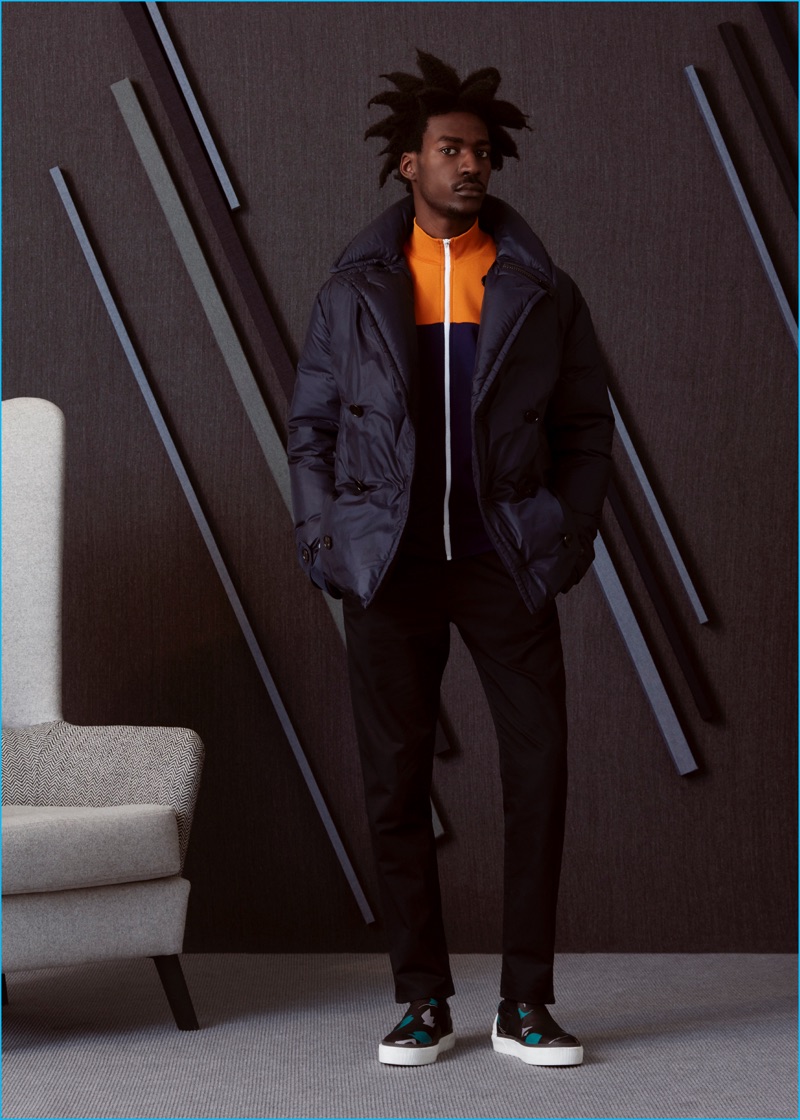 Boyd wears camouflage sneakers Lanvin, track jacket, down-filled jacket, and trousers Maison Margiela. 