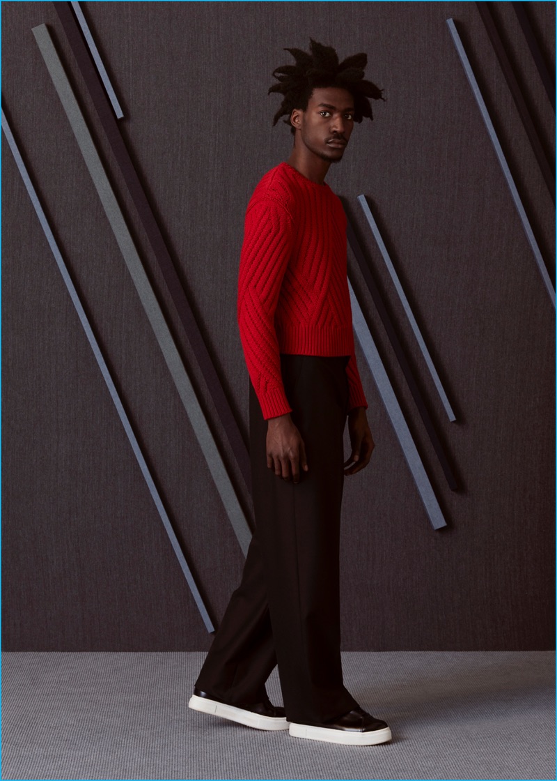 Boyd wears knit chevron sweater Neil Barrett, wide-leg trousers Lanvin, and sneakers EYTYS.