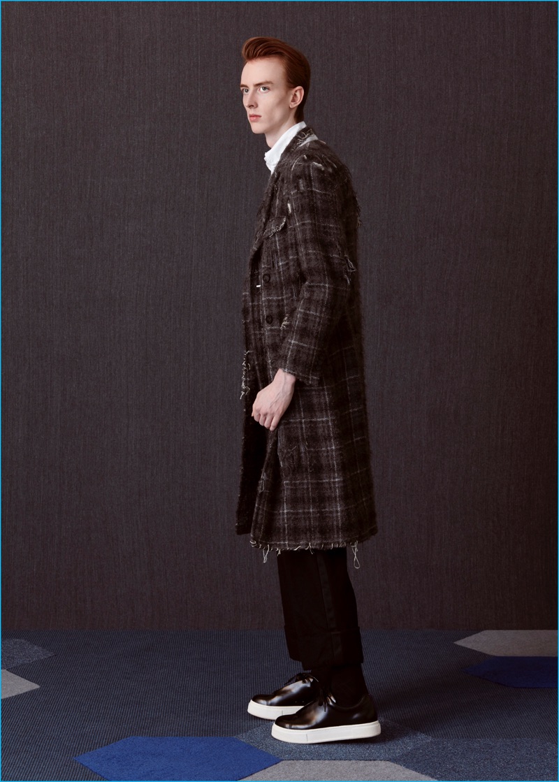 Matthew wears sneakers EYTYS, destroyed plaid overcoat and tuxedo trousers Thom Browne.