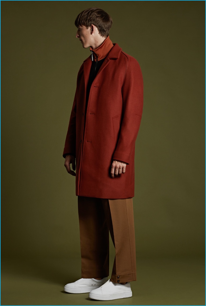 Wooyoungmi rust cashmere-blend overcoat and navy wool bomber jacket with Marni khaki loose-fit wool trousers, and EYTYS white leather Doja sneakers.