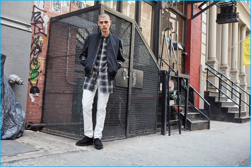 Micky Ayoub captured in New York, wearing a longline plaid shirt with white denim jeans.
