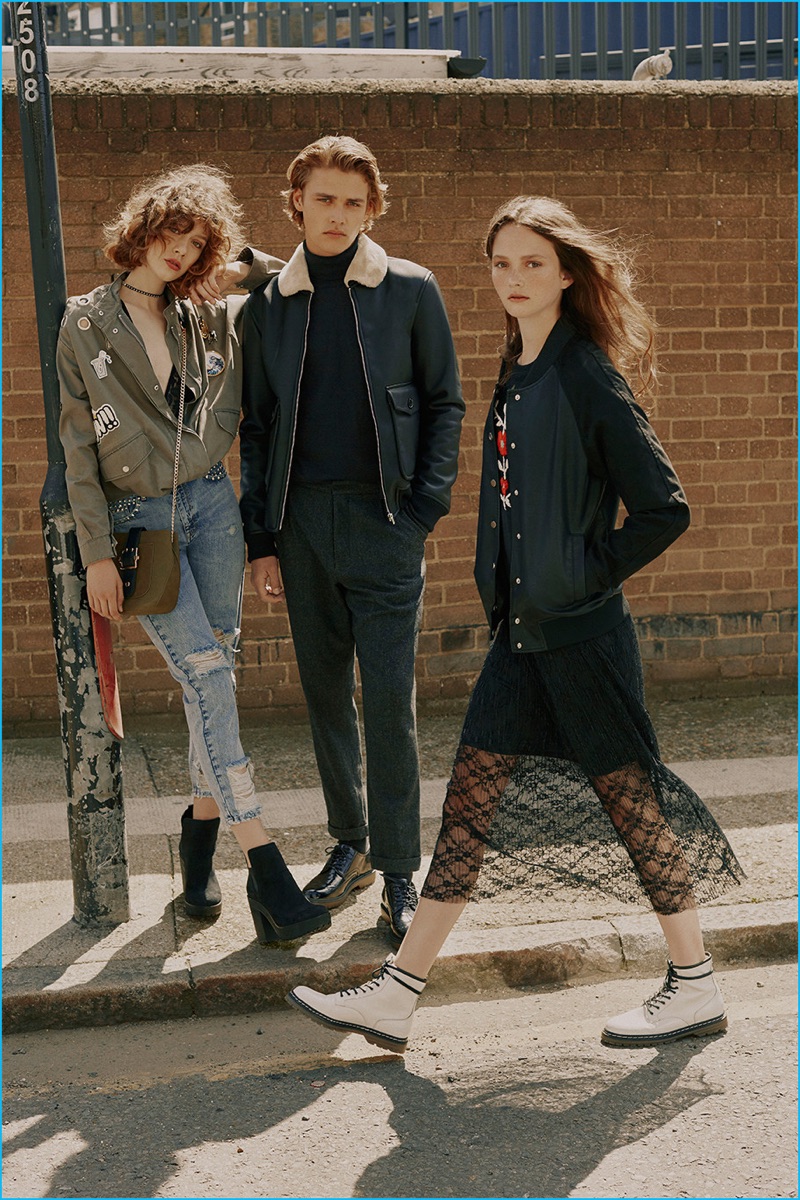 Posing alongside Sigrid Vieira and Allie Barrett, Billy Vandendooren channels sleek military style in a shearling collared leather bomber jacket.