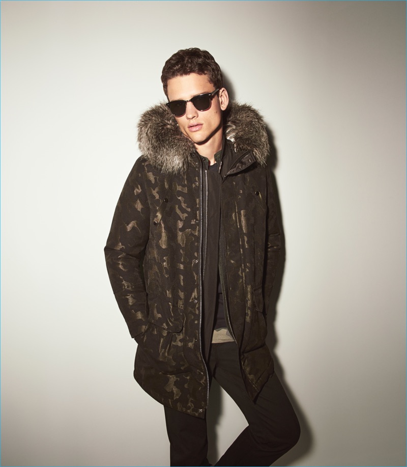Simon Nessman is a cool vision in a camouflage parka as he stars in River Island's fall-winter 2016 campaign.