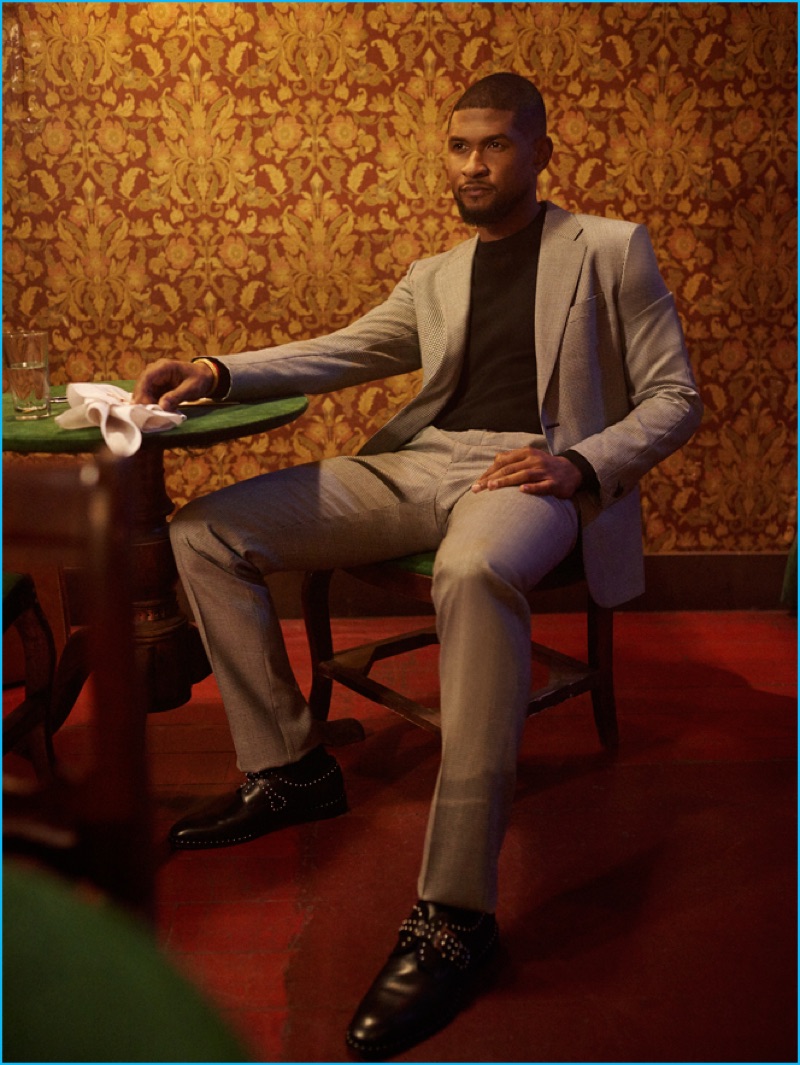 Usher pictured in a Versace suit with a Michael Kors t-shirt and Givenchy studded shoes.