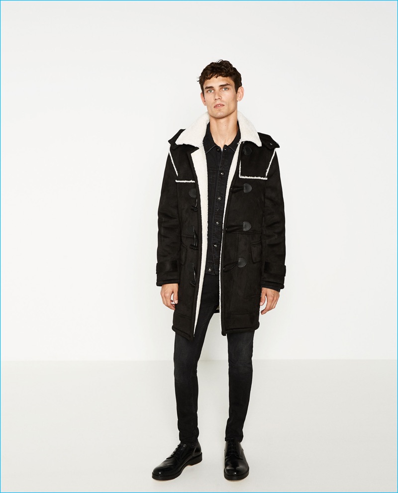 Arthur Gosse dons a black "shearling" duffle coat from Zara Man.