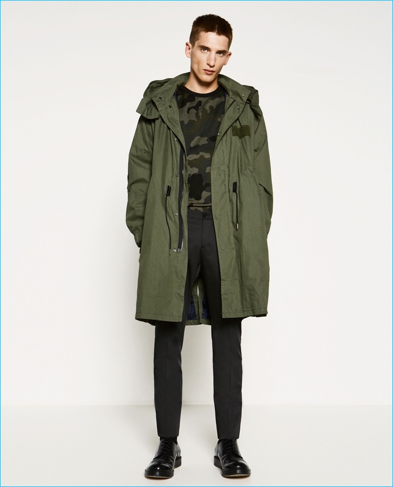 Anatol Modzelewski wears military greens, sporting an oversized parka and camouflage sweater from Zara Man.