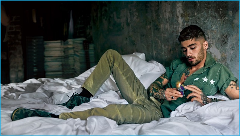 Zayn Malik stars in a GQ photo shoot, wearing Belstaff moto style pants with an Icons shirt, a Degs & Sal necklace, Giuseppe Zanotti Design camouflage chukka boots, and a David Yurman ring.