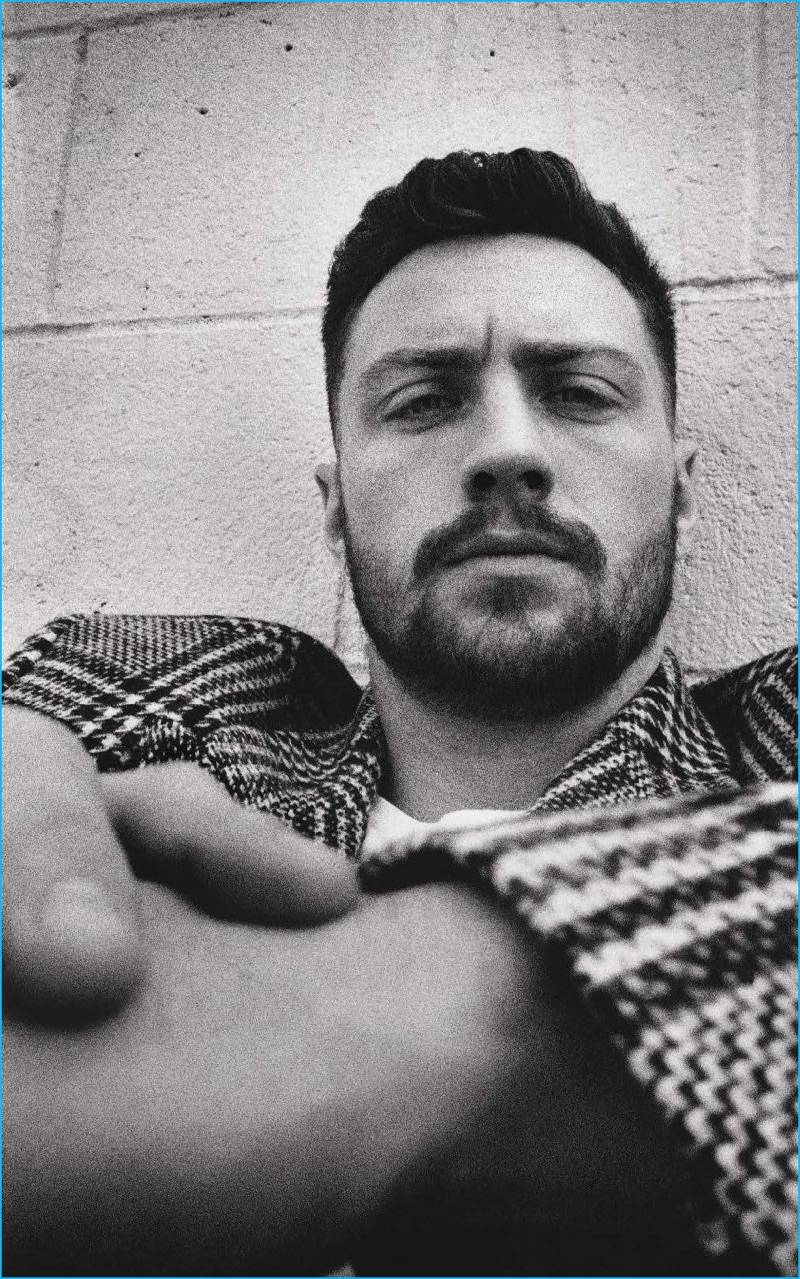 Aaron Taylor-Johnson poses in a houndstooth HUGO jacket for L'Uomo Vogue.