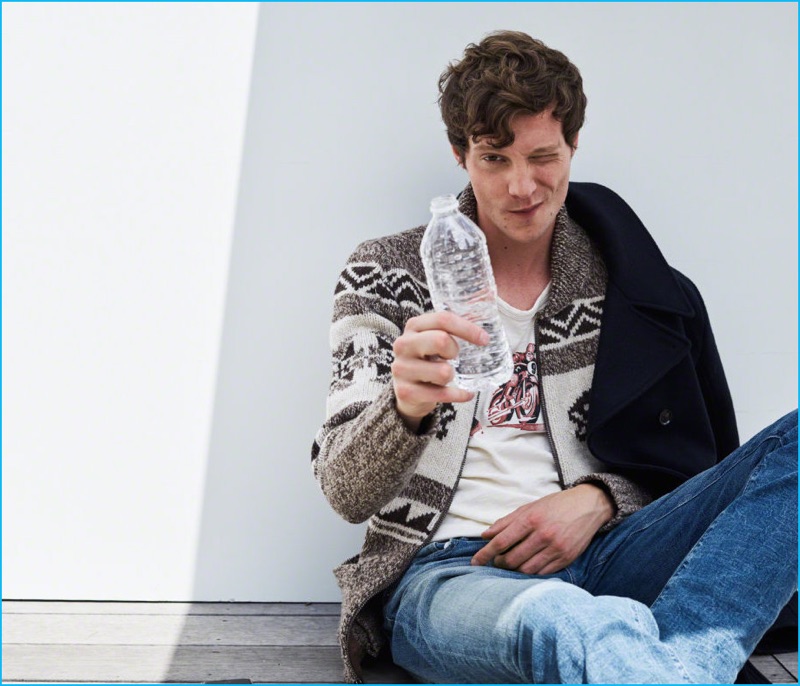 Model Matthew Hitt layers for fall in a patterned full-zip cardigan sweater with a graphic tee and distressed jeans from Abercrombie & Fitch.