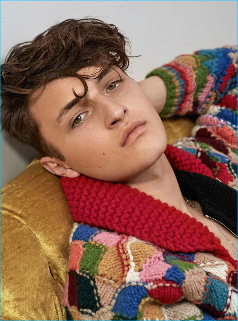 Anwar Hadid wears an intarsia cardigan sweater from Prada for Vogue Hommes Paris.