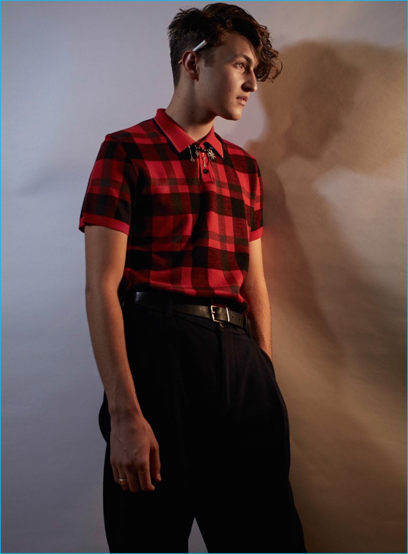 Anward Hadid models a red and black buffalo check polo shirt from Coach for Vogue Hommes Paris.