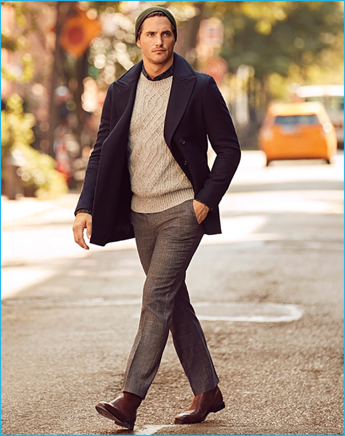 Ollie Edwards goes for a New York stroll. The English model dons Banana Republic's standard grey plaid wool suit trousers with a check shirt, modern cable crew sweater, knit beanie, brown leather Justin boots, and a wool blend peacoat.