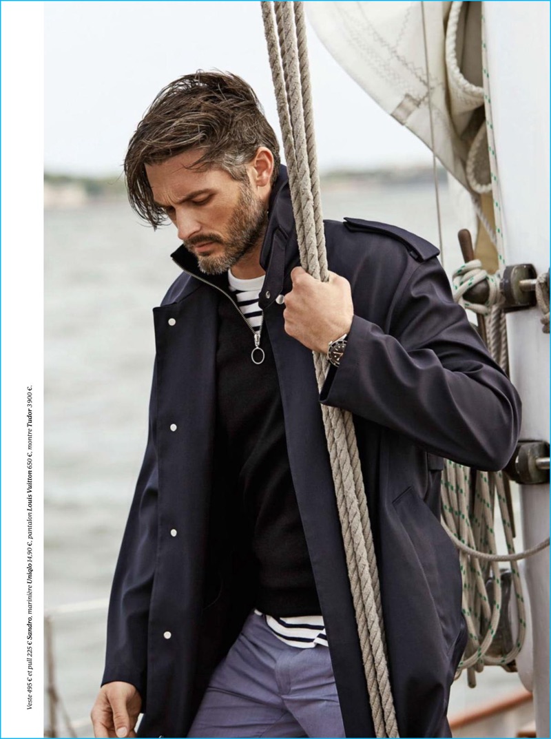 Ben Hill embraces nautical style in a striped Uniqlo top with Louis Vuitton trousers, as well as a pullover and coat from Sandro.
