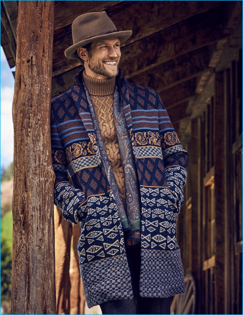 Jan Trojan charms in a fedora Albertus Swanepoel, knit coat, turtleneck sweater, and trousers Etro.
