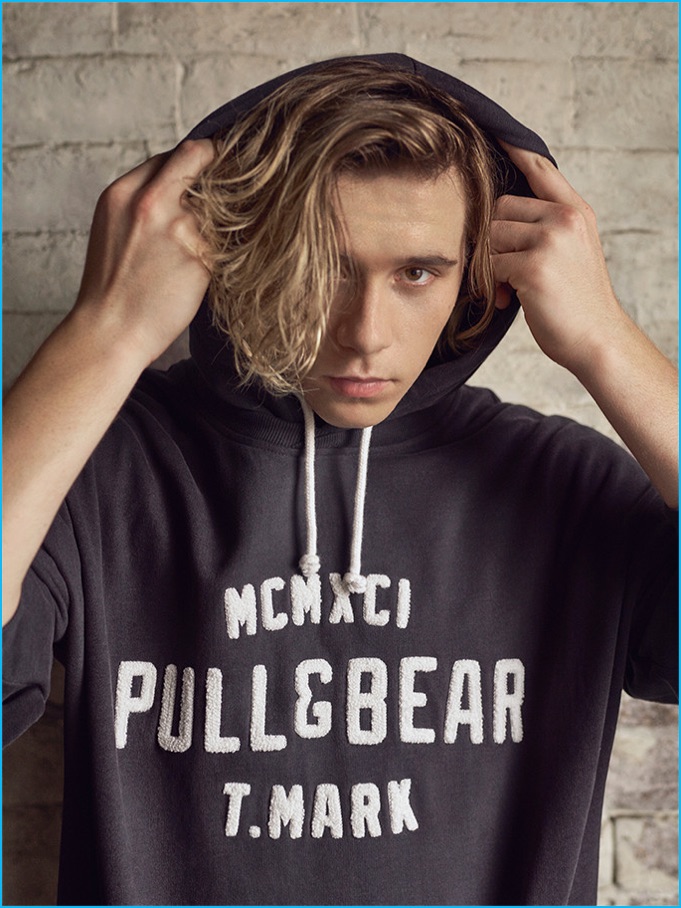 Brooklyn Beckham models a Pull & Bear hoodie.
