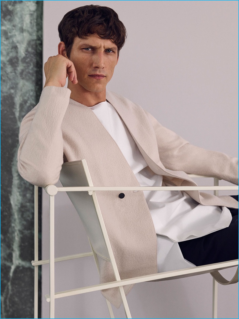 Roch Barbot is a chic vision in a double-breasted wool cardigan, round neck shirt, and drawstring tailored trousers from COS' fall-winter 2016 Studio collection.