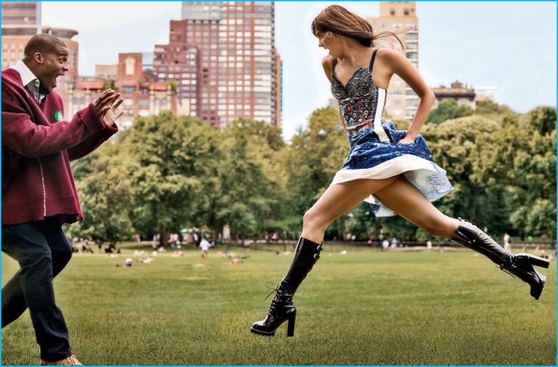 Posing for a flirty picture with Karlie Kloss, Cam Newton wears a Raf Simons sweater with a Tom Ford shirt, Baldwin jeans, and Clarks boots.