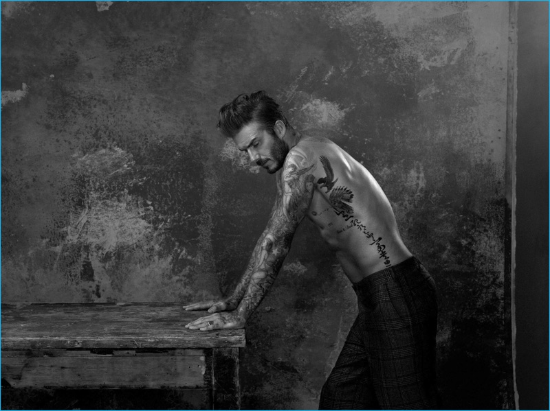 David Beckham goes shirtless for his Madame Figaro photo shoot, wearing check trousers from Junya Watanabe.
