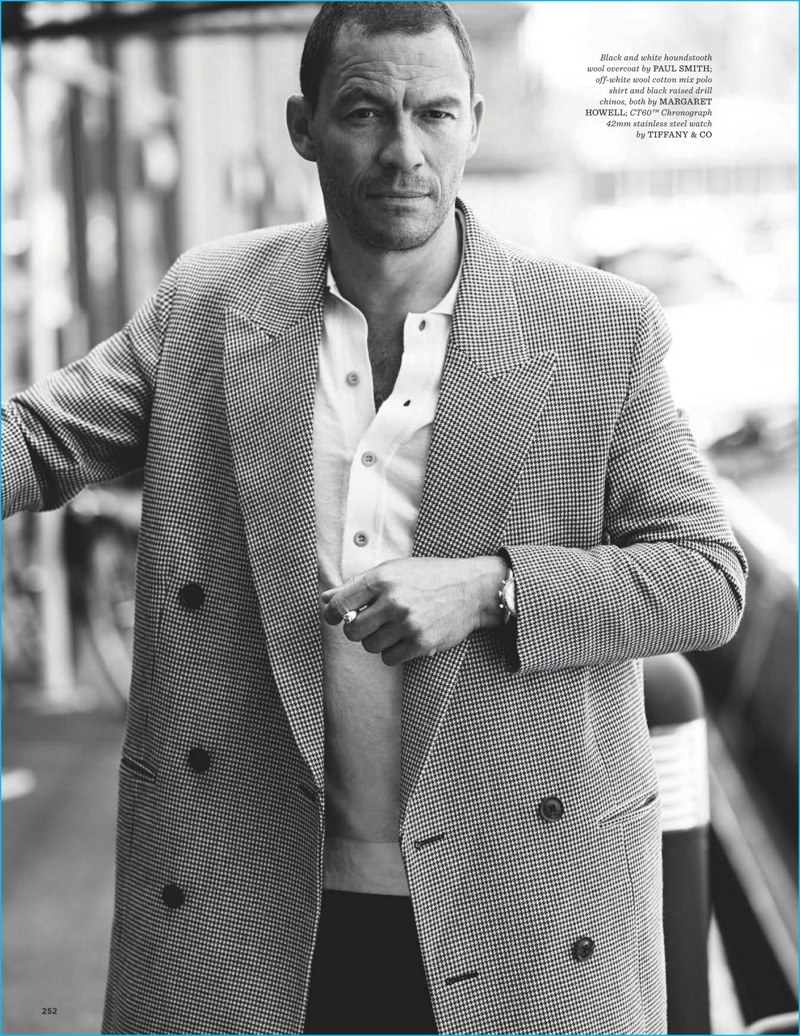 Dominic West dons a houndstooth Paul Smith coat with a polo and chinos from Margaret Howell.