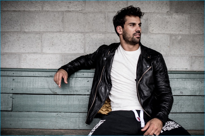 Eric Decker wears Superdry's Endurance Indy leather biker jacket, Surplus Good pocket t-shirt, and Trackster non cuffed joggers for the brand's fall-winter 2016 campaign.