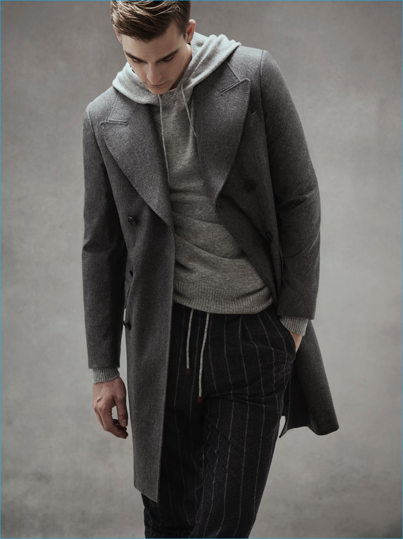 Grey Layers: Thorben Gartner wears grey pinstripe trousers Brunello Cucinelli, coat and knit hoodie E.Tautz.