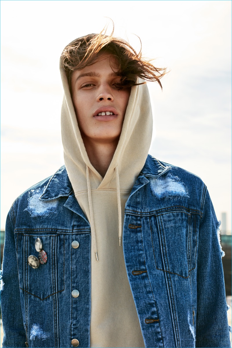 Lucas Satherley sports a denim jacket with a casual hoodie for Forever 21's fall 2016 campaign.