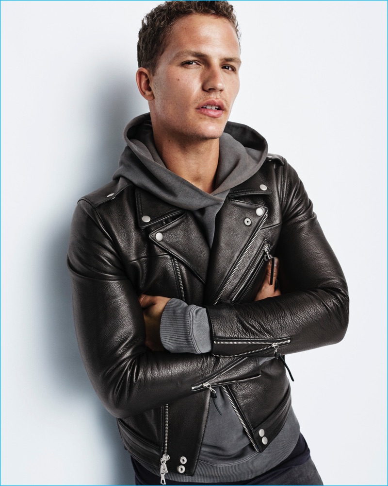 Nathaniel Visser rocks a leather biker jacket and sweatshirt from John Elliott for Gap x GQ's Best New Menswear Designers in American All-Stars limited-edition collection.