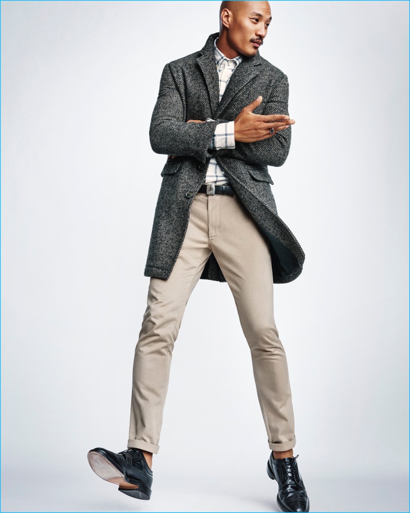 Paolo Roldan pictured in a single-breasted coat, check shirt, and khaki pants from Steven Alan for Gap x GQ's Best New Menswear Designers in American All-Stars limited-edition collection.