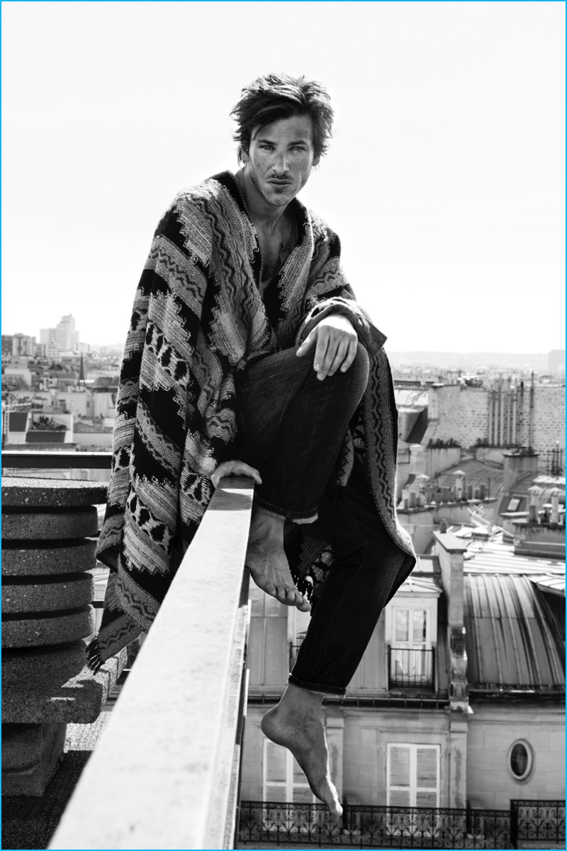 Gaspard Ulliel wears a striking poncho from Valentino for L'Express Styles.