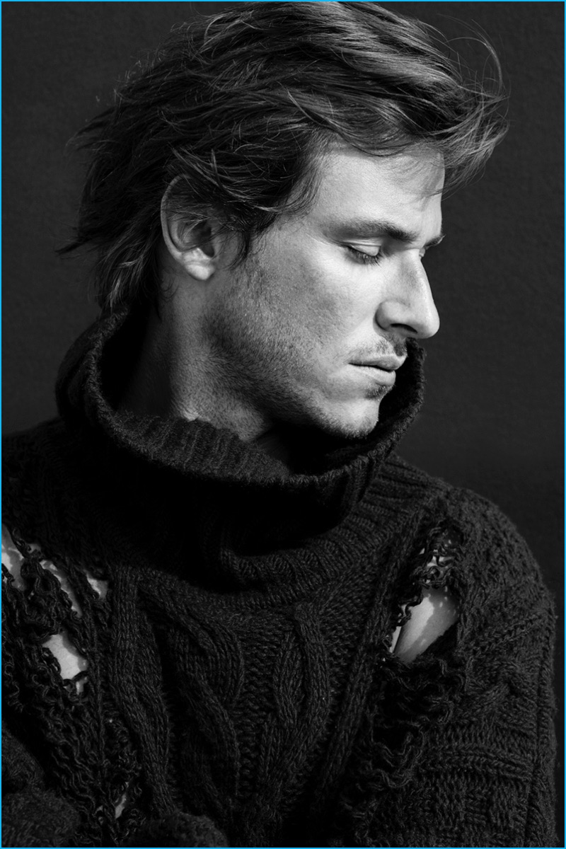 Posing for a portrait, Gaspard Ulliel wears a distressed sweater from Faith Connexion for L'Express Styles.
