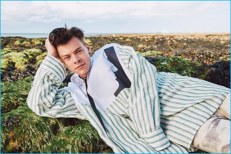 Harry Styles relaxes in an oversized stripe shirt from Raf Simons' spring-summer 2017 collection.