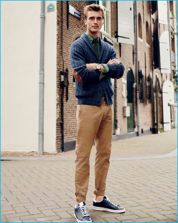 Clément Chabernaud poses in the streets of Amsterdam, wearing J.Crew's stretch chinos with an elbow patched cardigan sweater.