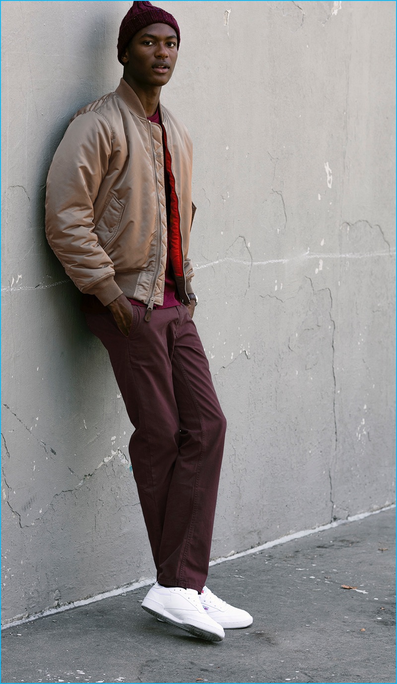 Model Hamid Onifade sports a bomber jacket with burgundy pants from JackThreads.