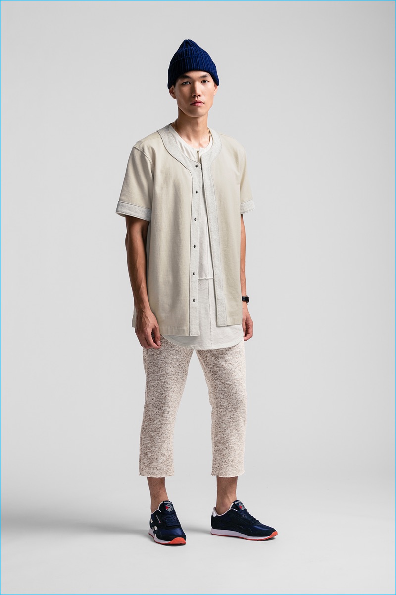 Danny Lim pictured in cropped pants with a longline shirt and baseball shirt.