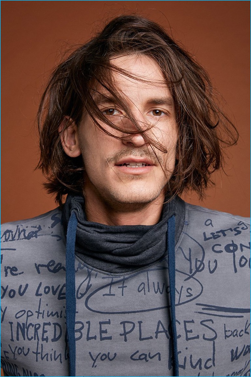 Jarrod Scott rocks a writing print cowl neck pullover from Desigual's fall-winter 2016 men's range.