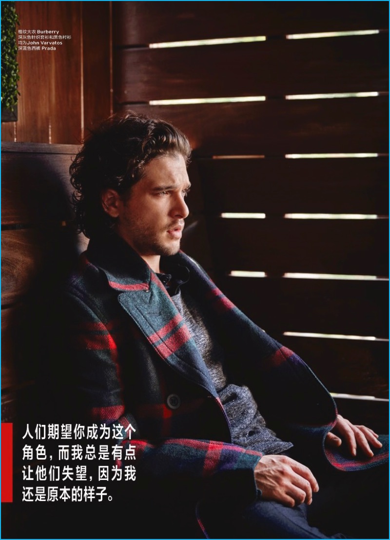 Kit Harington dons a Burberry check coat with casual fashions from John Varvatos and Prada.