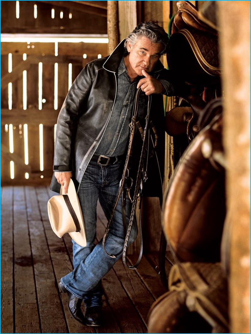 Kurt Russell embraces a rugged edge in an Emporio Armani leather jacket with a Saint Laurent denim shirt, 7 For All Mankind denim jeans, John Varvatos belt, Corral boots and vintage Stetson hat.