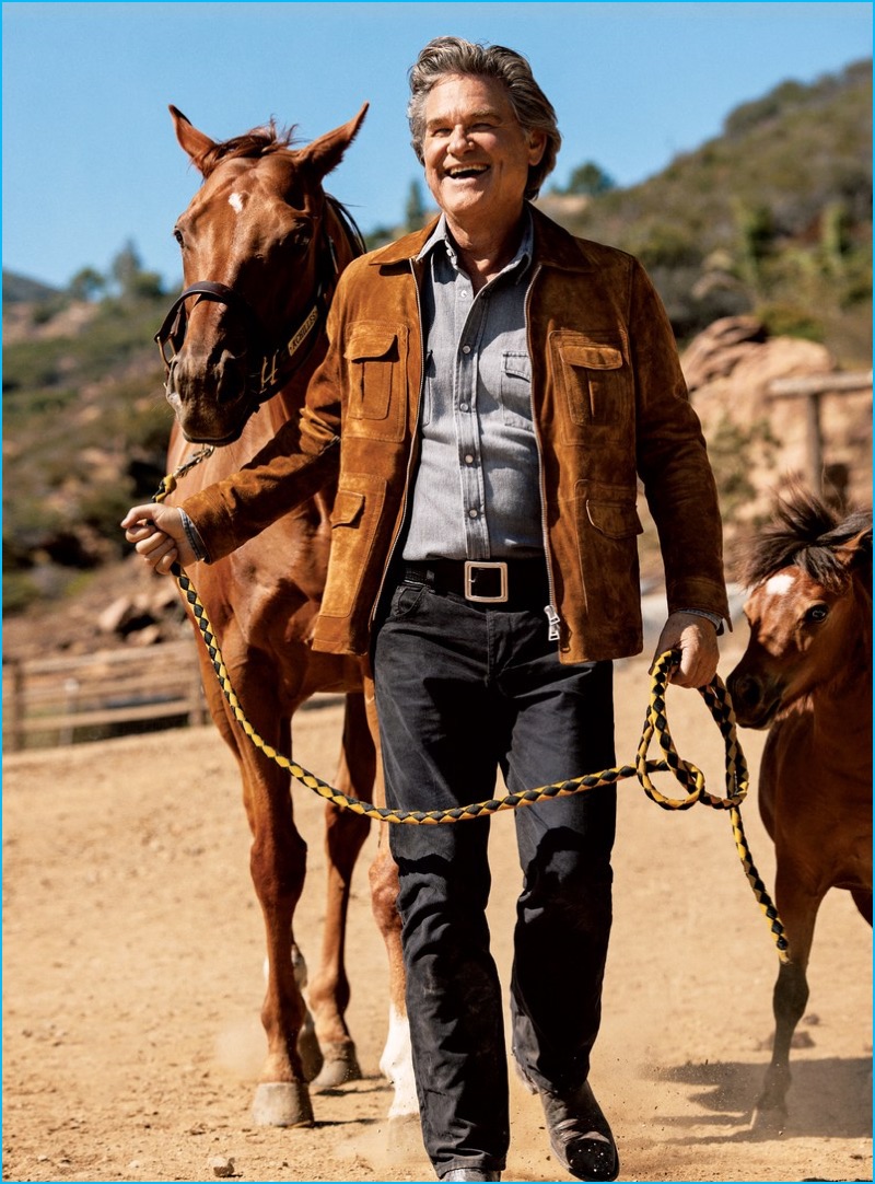 Pictured with horses, Kurt Russell wears a Tom Ford suede jacket, shirt and leather belt with Rag & Bone Standard Issue denim jeans.