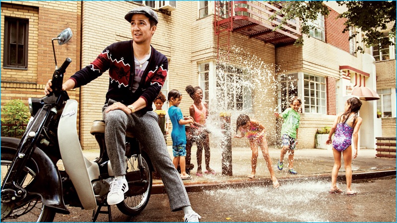 Lin-Manuel Miranda pictured in a Lanvin cardigan with a What Goes Around Comes Around vintage t-shirt, Joseph Abboud herringbone trousers, Stetson newsboy cap, and Adidas sneakers for GQ.
