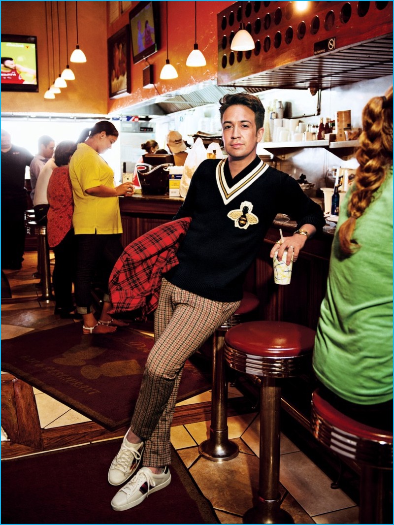 Lin-Manuel Miranda embraces preppy style in a varsity sweater, check trousers and sneakers from Gucci for GQ.