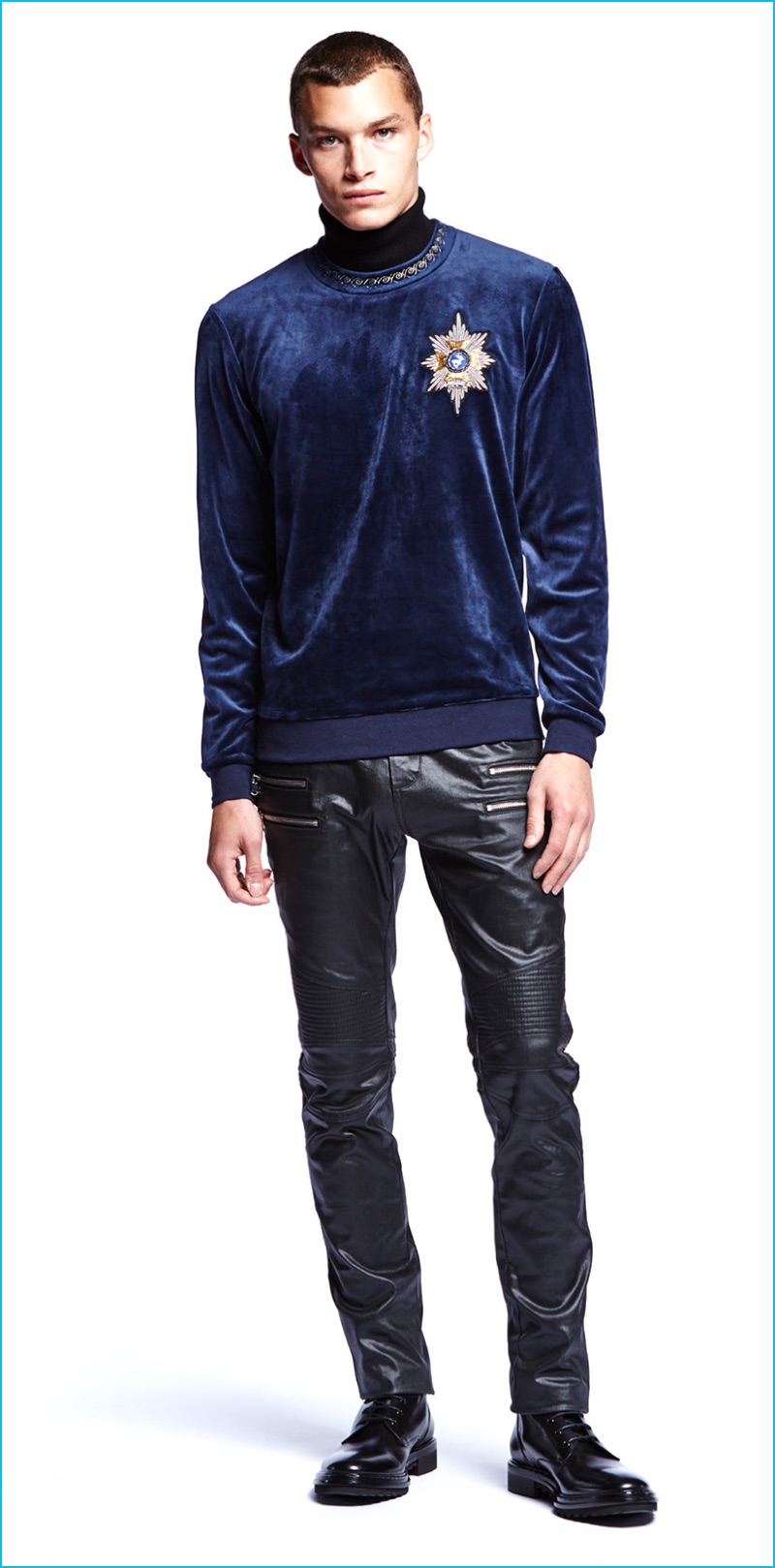 Louis Mayhew wears Laboratory velvet sweatshirt with embroidered patch and black coated moto jeans.