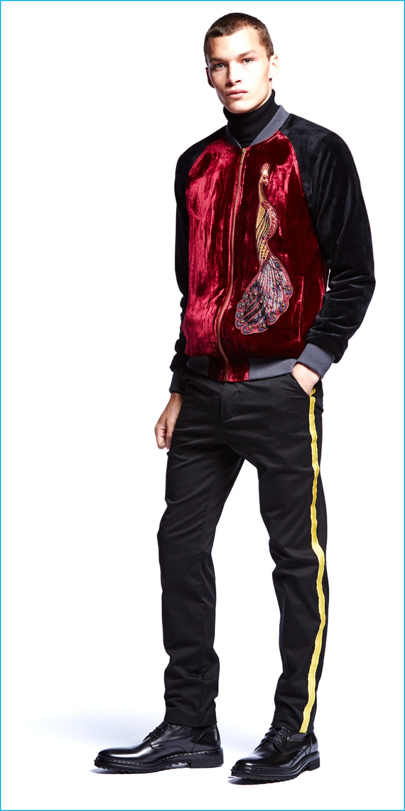 Louis Mayhew wears Laboratory embroidered peacock velvet jacket and track pants with metallic trim.