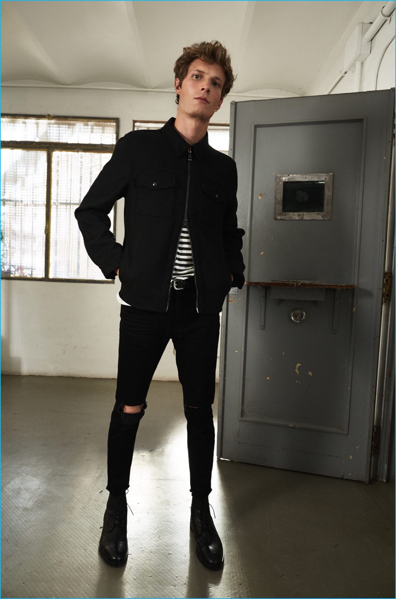 Felix Gesnouin rocks all black in skinny jeans, ripped at the knees with a striped cotton t-shirt from Mango Man.