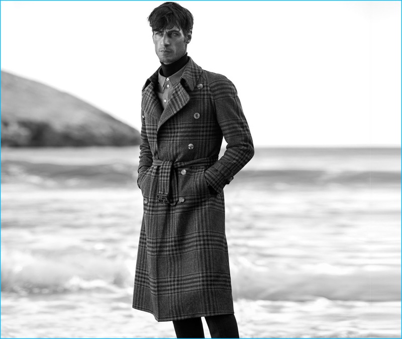 Axel Hermann wears double-breasted tartan trench Gucci, double-collar shirt By Walid, turtleneck cashmere sweater Alexander McQueen, and flared trousers Burberry.